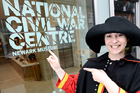 A costumed performer portrays Aphra Behn outside the National Civil War Centre